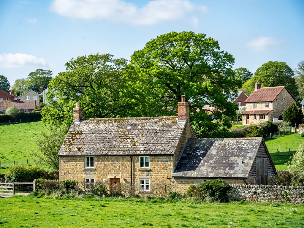 Sandstone farmhouse and barn with Horsham stone roofs in the Sussex Weald