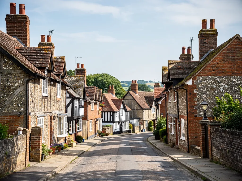 Steyning street of old flint, brick and timber-framed buildings with tiled and stone roofs