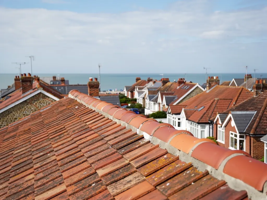 Freshly re-bedded clay ridge tiles on a tiled roof
