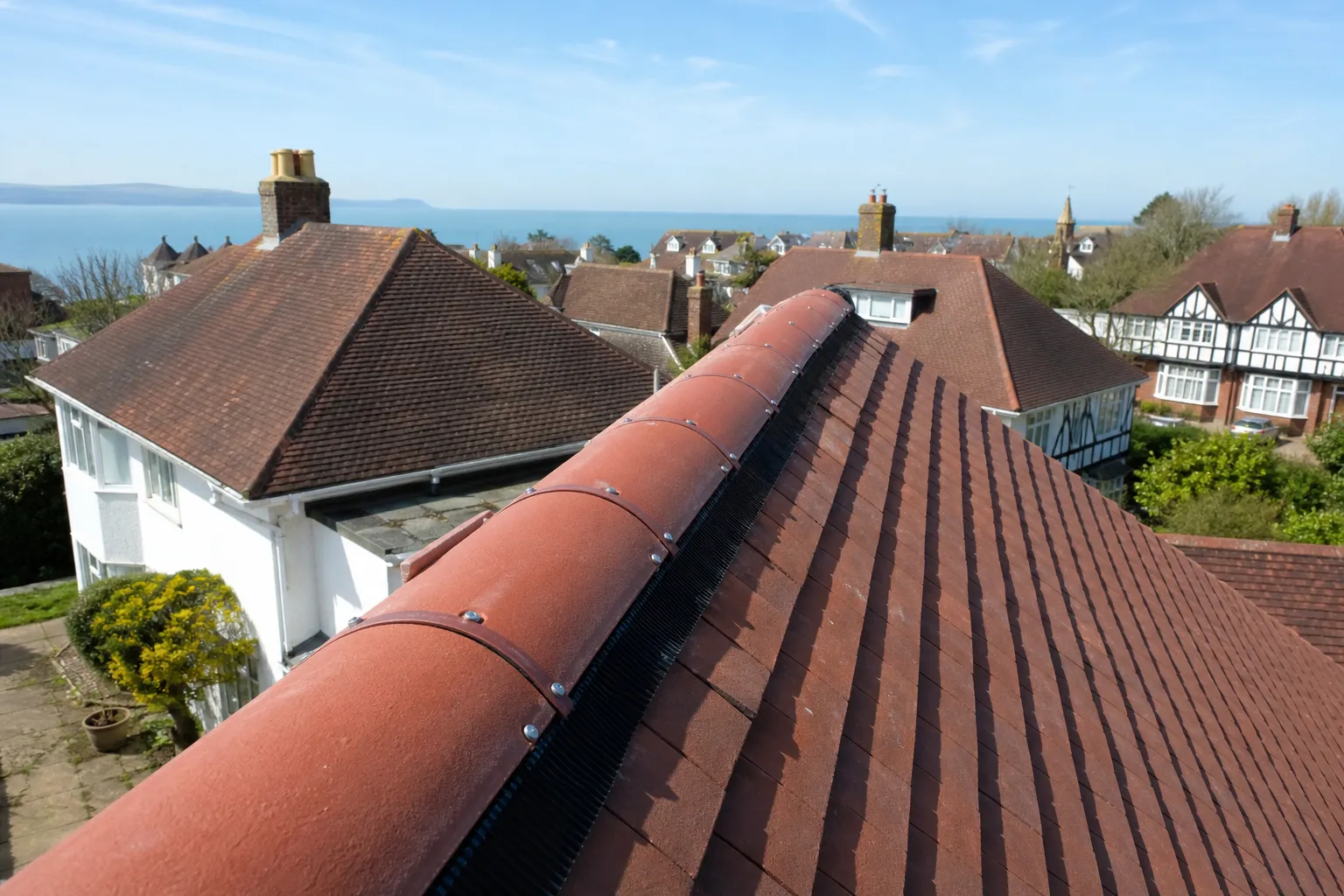The same clay ridge re-laid on a dry-fix system, clipped and screwed to the ridge board